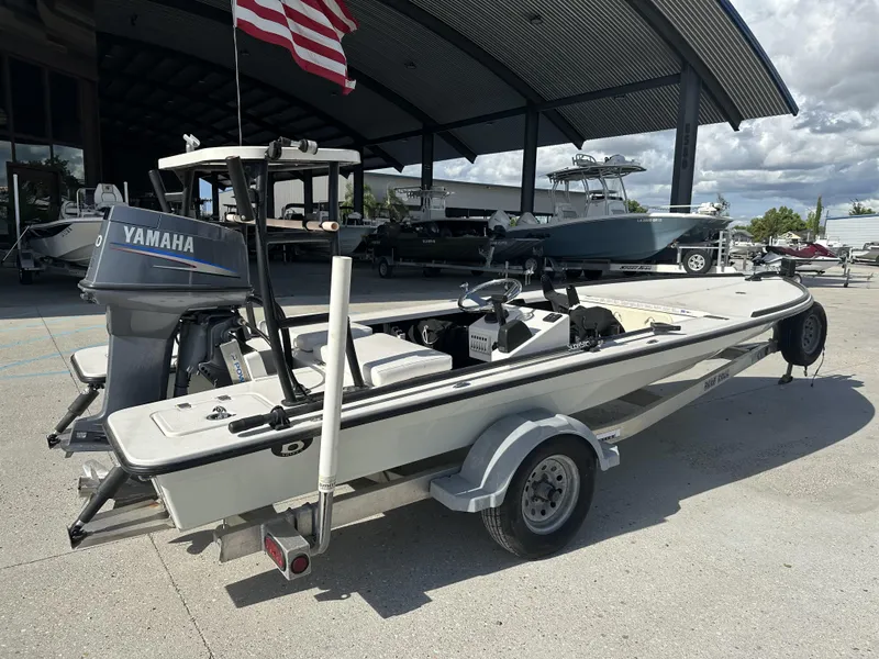 Slide: The Image of 2006 Beavertail Skiffs 16 with Yamaha motor on trailer, parked under a canopy. - 5