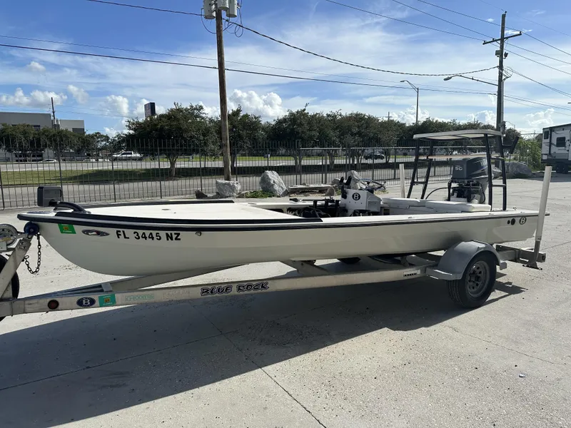 Slide: The Image of 2006 Beavertail Skiffs 16 on trailer, parked outdoors under clear sky. - 6