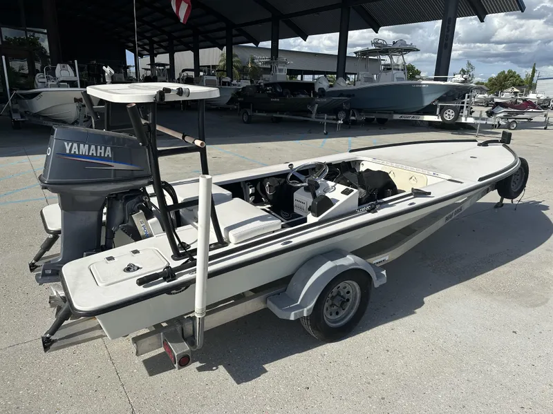 Slide: The Image of 2006 Beavertail Skiffs 16 with Yamaha engine on trailer, parked outdoors. - 7