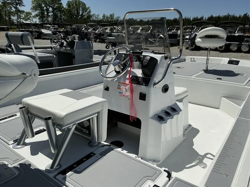 Slide: The Image of 2025 G3 Bay 20 boat interior with steering console and seating, displayed outdoors. - 7