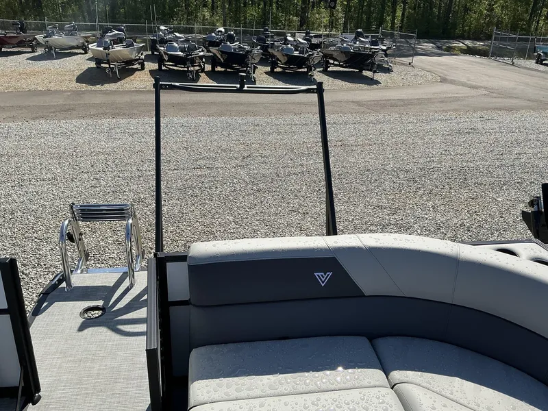 Slide: The Image of 2025 Viaggio Lago V 20 C boat interior with ladder, parked boats in background. - 10