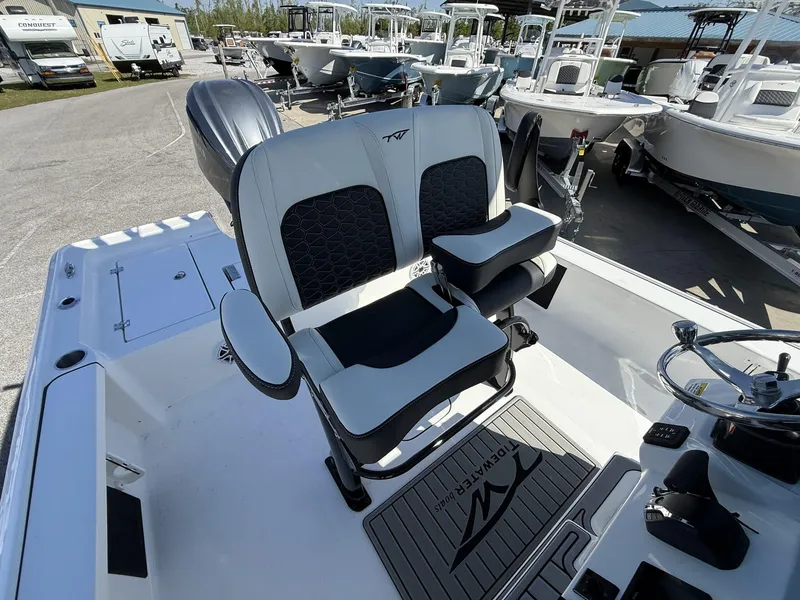 Slide: The Image of 2025 Tidewater 2410 Bay Max boat interior with dual seats and steering wheel. - 14