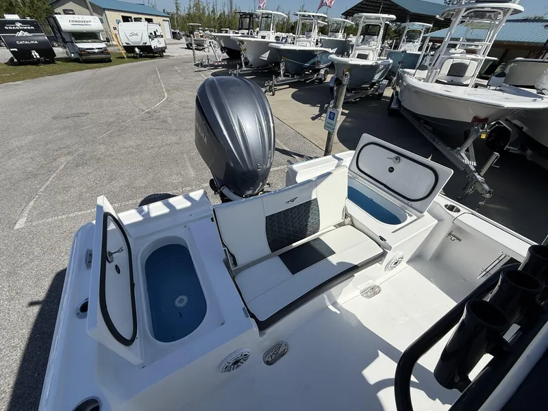 Slide: The Image of 2025 Tidewater 2410 Bay Max boat interior with seating and storage compartments. - 15
