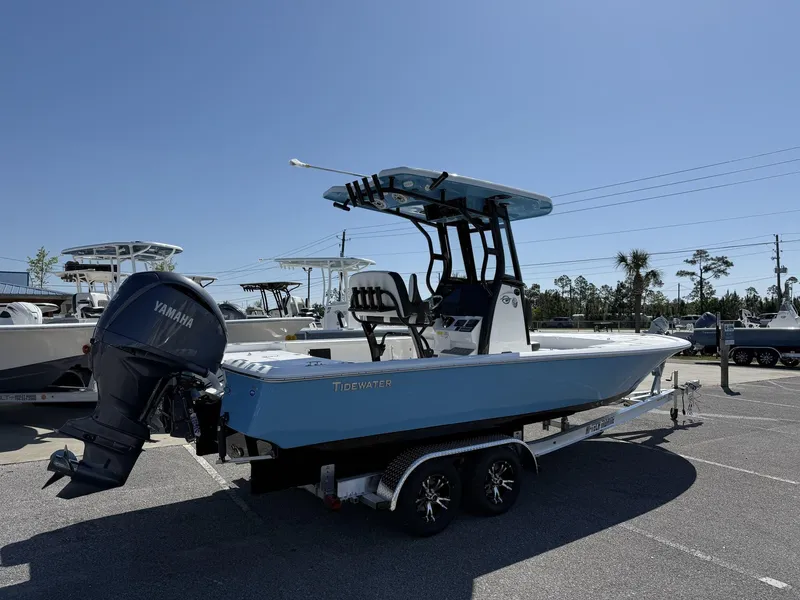 Slide: The Image of 2025 Tidewater 2410 Bay Max boat with Yamaha engine on trailer, parked outdoors. - 3