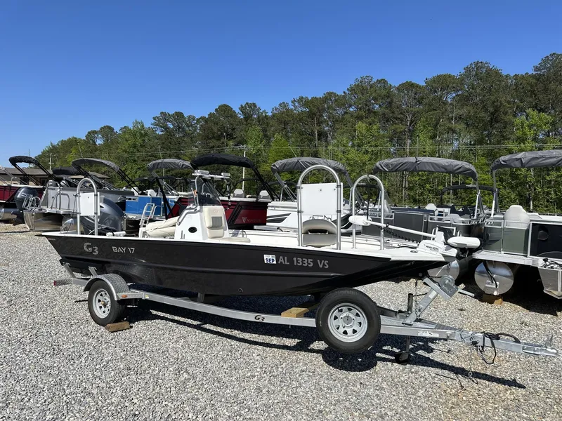 Slide: The Image of 2022 G3 Bay 17 boat on trailer, parked outdoors with other boats. - 1