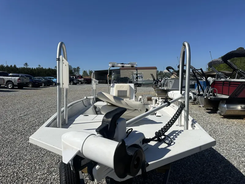 Slide: The Image of 2022 G3 Bay 17 BAY boat in a gravel lot, surrounded by other boats and vehicles. - 2