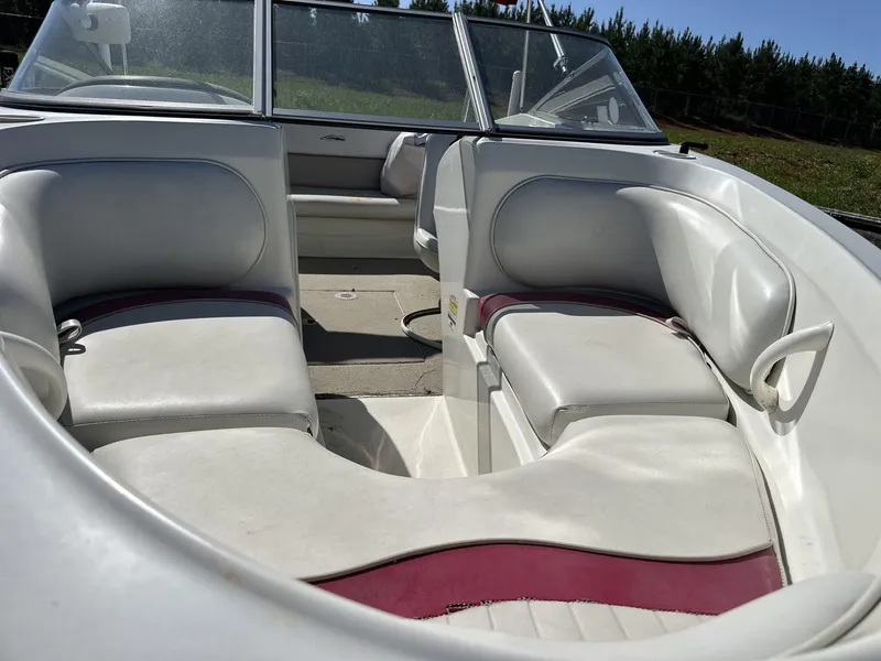 Slide: The Image of 2007 Caravelle 182 186 boat interior with white and maroon seating, open deck view. - 4