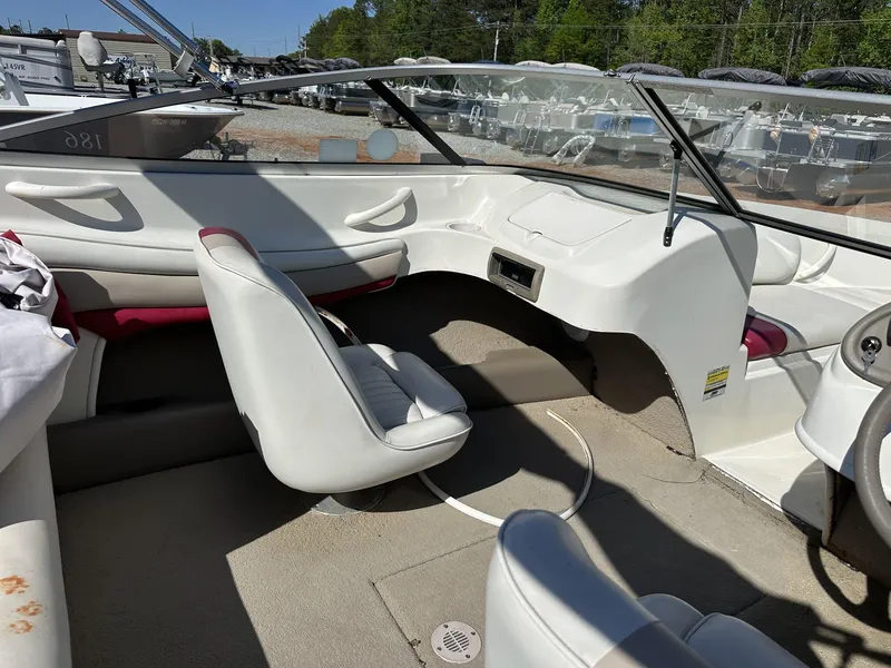 Slide: The Image of Interior of a 2007 Caravelle 182 186 MODEL boat with white seating and dashboard. - 6