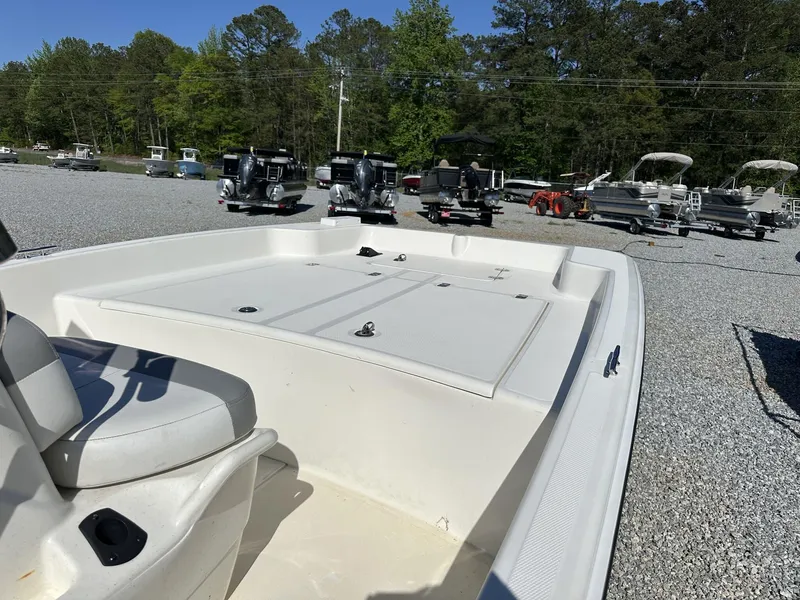Slide: The Image of 2019 Mako Pro Skiff 17 boat on gravel lot with other boats. - 10