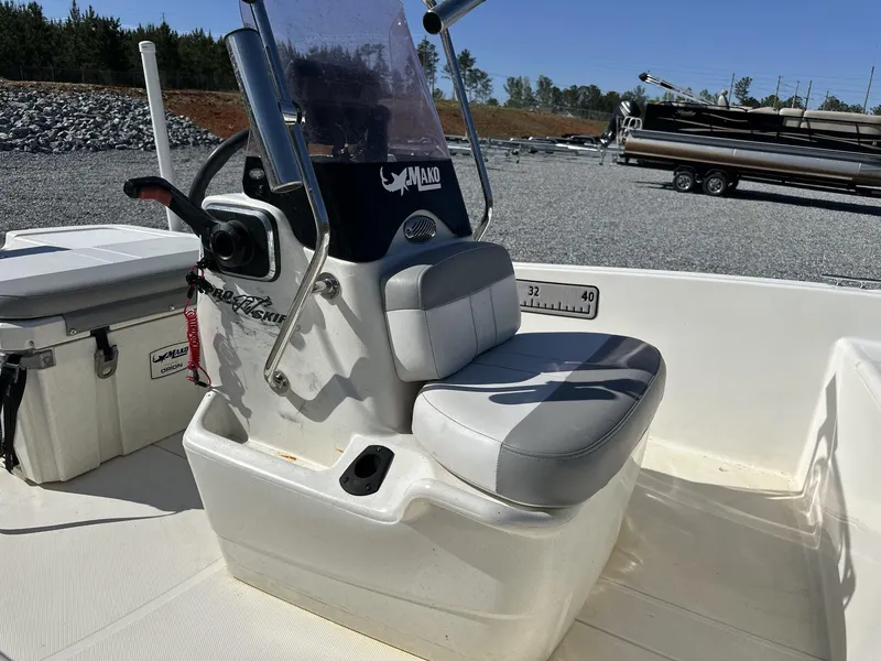 Slide: The Image of 2019 Mako Pro Skiff 17 boat interior with steering console and cushioned seat. - 3
