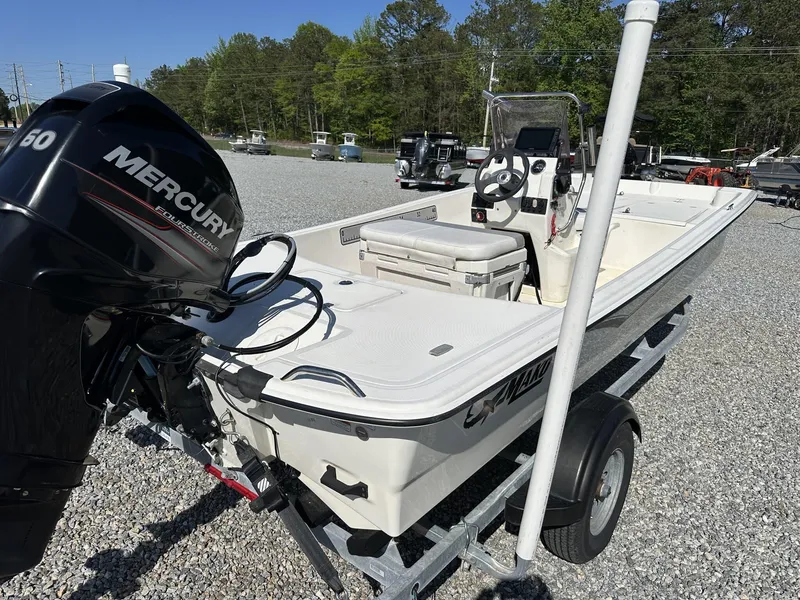 Slide: The Image of 2019 Mako Pro Skiff 17 boat with Mercury engine on trailer, parked outdoors. - 6