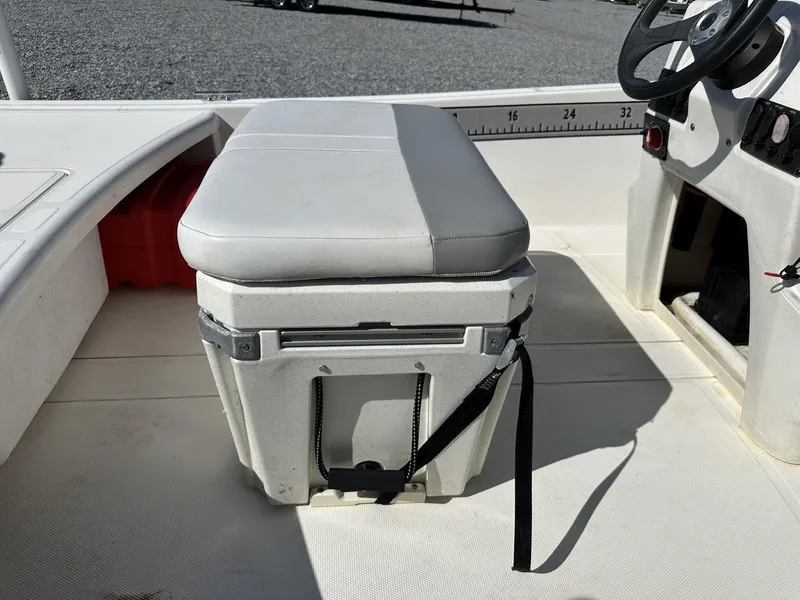 Slide: The Image of 2019 Mako Pro Skiff 17 boat interior with cushioned seat and steering wheel. - 9