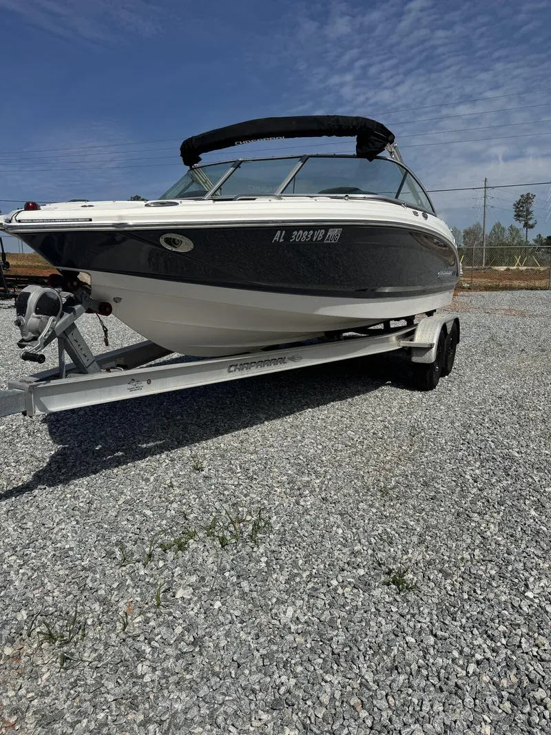 Slide: The Image of 2014 Chaparral 206 SSi boat on trailer, parked on gravel under a clear sky. - 2
