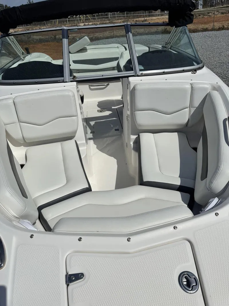 Slide: The Image of 2014 Chaparral 206 SSi boat interior with white seating and windshield. - 4