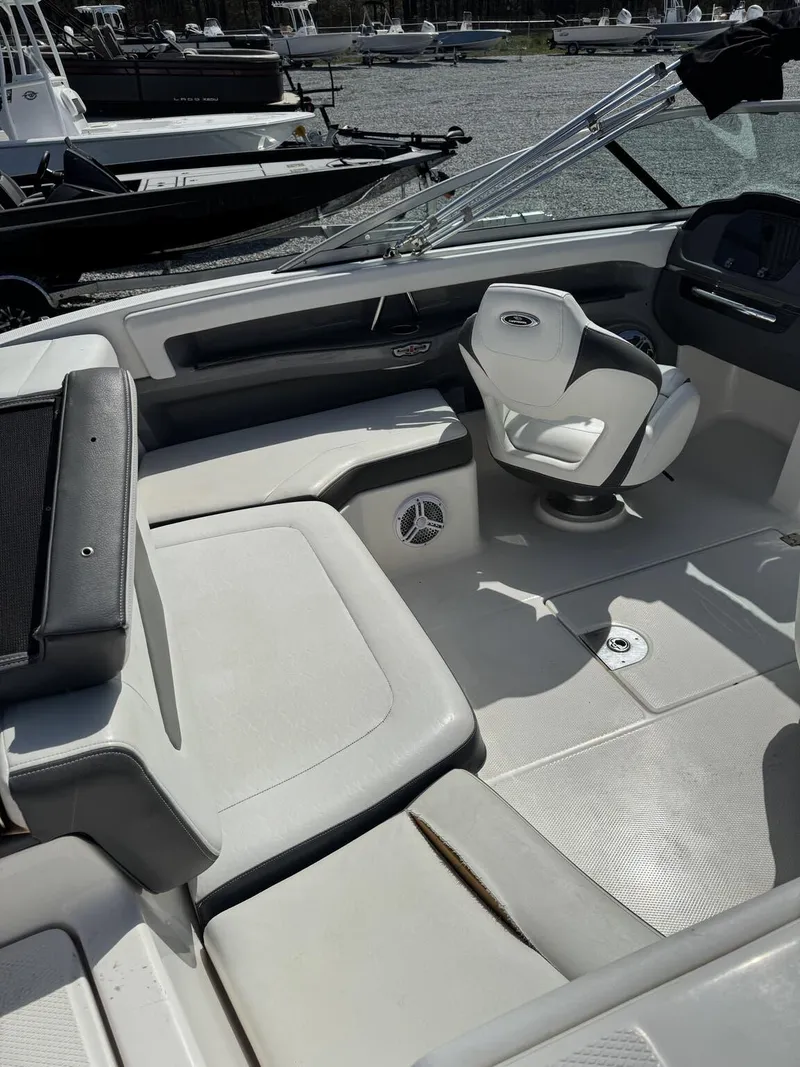 Slide: The Image of 2014 Chaparral 206 SSi boat interior with white seating and steering area. - 5