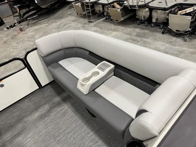 Slide: The Image of 2023 Sweetwater 2286 boat interior with gray seating and cup holders. - 11