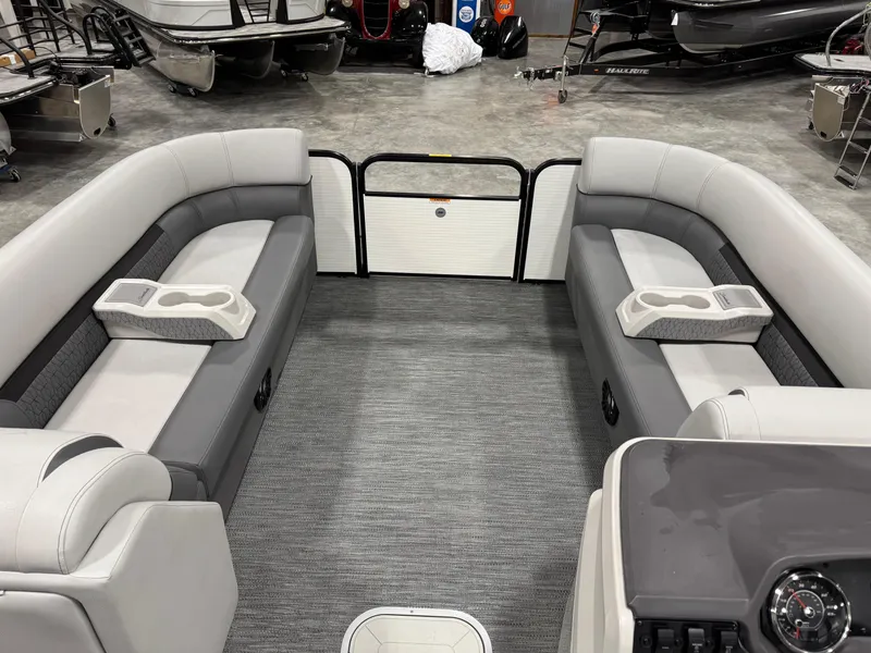 Slide: The Image of Interior of 2023 Sweetwater 2286 pontoon boat with gray seating and cup holders. - 13