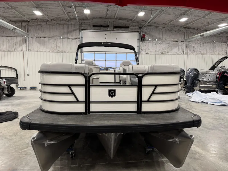 Slide: The Image of 2023 Sweetwater 2286 pontoon boat in a spacious indoor showroom. - 5