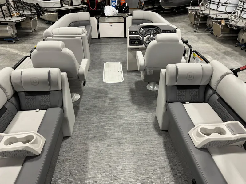 Slide: The Image of 2023 Sweetwater 2286 pontoon boat interior with plush seating and modern dashboard. - 6