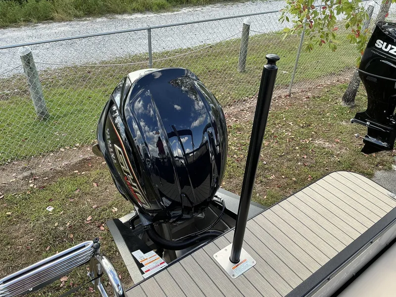 Slide: The Image of 2025 Veranda Relax Series VR22VLC boat with sleek black outboard motor. - 7