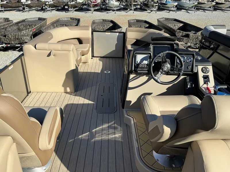 Slide: The Image of 2025 Veranda Relax Series 22RC boat interior with beige seating and modern dashboard. - 10