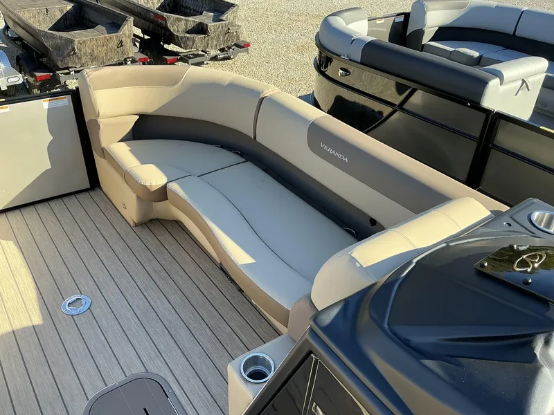 Slide: The Image of 2025 Veranda Relax Series 22RC pontoon boat with beige seating and wood-style flooring. - 11