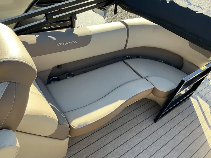Slide: The Image of 2025 Veranda Relax Series 22RC boat interior with beige seating and cup holders. - 12