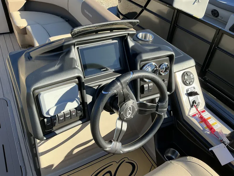 Slide: The Image of 2025 Veranda Relax Series 22RC boat dashboard with steering wheel and control panel. - 14