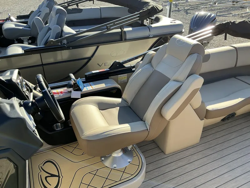 Slide: The Image of 2025 Veranda Relax Series 22RC boat interior with plush seating and steering console. - 15