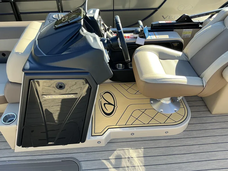 Slide: The Image of Captain's seat and console of 2025 Veranda Relax Series 22RC boat, featuring luxury design. - 16