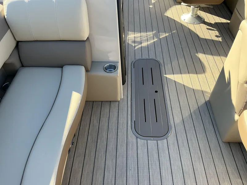 Slide: The Image of 2025 Veranda Relax Series 22RC boat interior with cushioned seating and sleek flooring. - 19