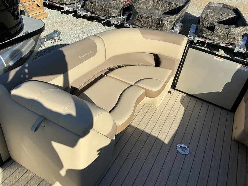Slide: The Image of 2025 Veranda Relax Series 22RC boat interior with beige seating and wood-style flooring. - 6