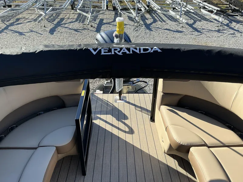 Slide: The Image of 2025 Veranda Relax Series 22RC pontoon boat with beige seating and black cover. - 8