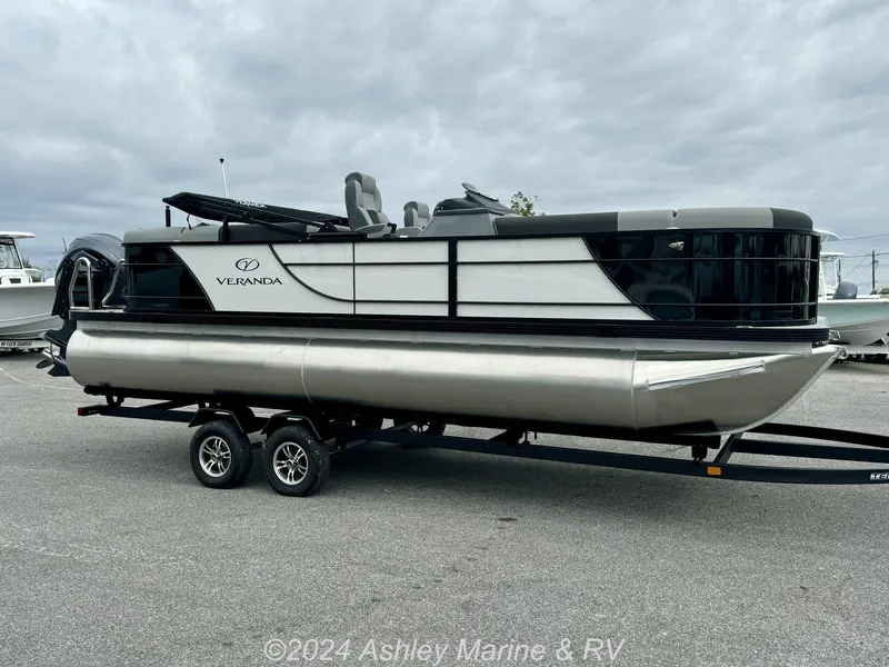 Slide: The Image of 2025 Veranda Relax Series 22RC pontoon boat on trailer, displayed outdoors. - 2