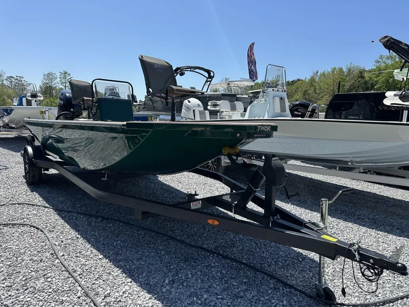 Slide: The Image of 2025 Thor LAKE HAMMER 1900 CC boat on trailer, displayed outdoors on gravel. - 12