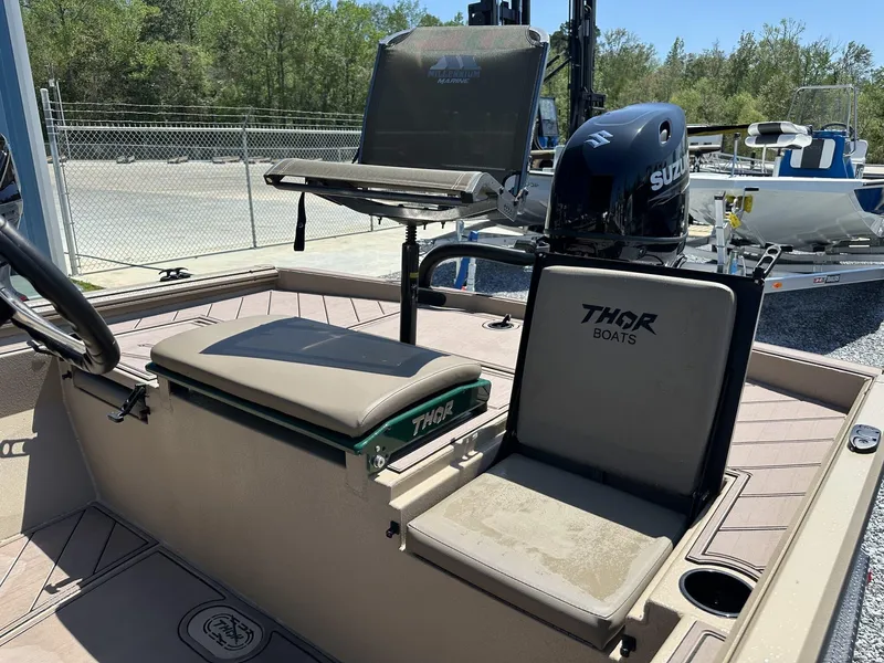 Slide: The Image of 2025 Thor LAKE HAMMER 1900 CC boat interior with Suzuki engine, featuring comfortable seating. - 13