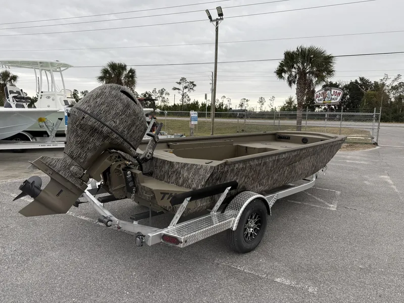 Slide: The Image of 2025 Thor LAKE HAMMER 1860 boat on trailer, parked outdoors with palm trees in background. - 3