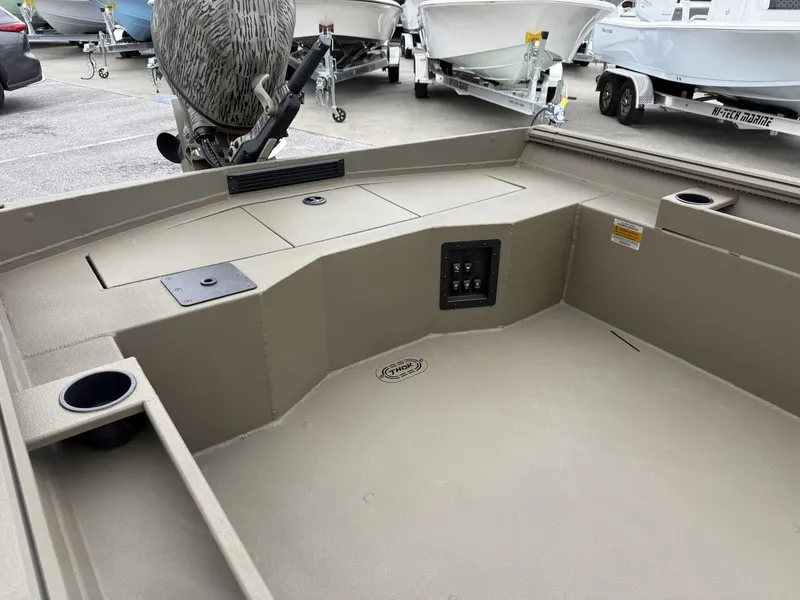 Slide: The Image of 2025 Thor LAKE HAMMER 1860 boat interior with control panel and storage compartments. - 6