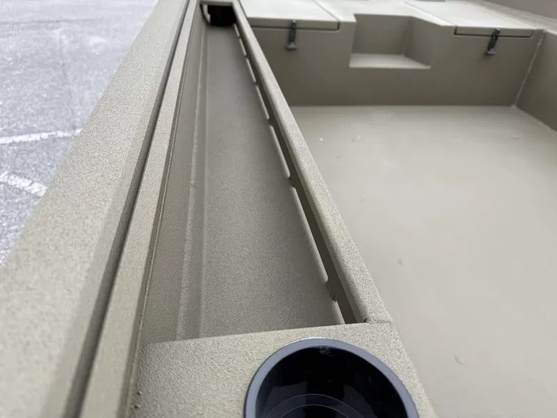 Slide: The Image of 2025 Thor LAKE HAMMER 1860 boat interior, showcasing storage compartments and cup holder. - 9