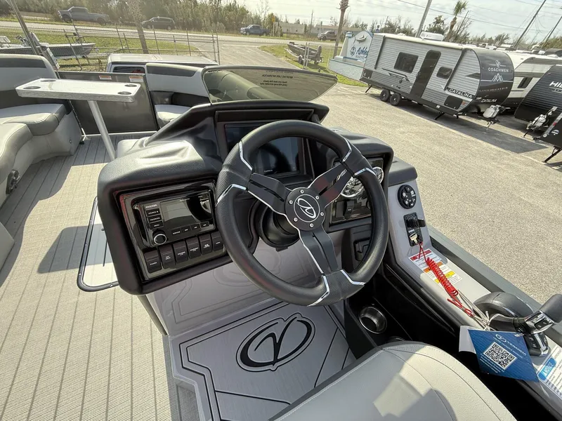 Slide: The Image of Interior of 2025 Veranda Relax Series VR25RC boat, featuring steering wheel and control panel. - 10