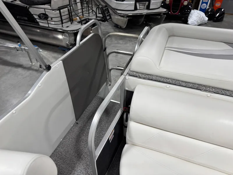 Slide: The Image of 2015 PlayCraft 2600 Sport Toon interior with white seating and metal railings. - 11