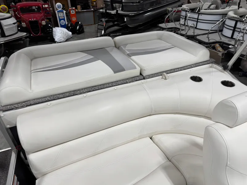 Slide: The Image of 2015 PlayCraft 2600 Sport Toon boat interior with white leather seating and cup holders. - 12