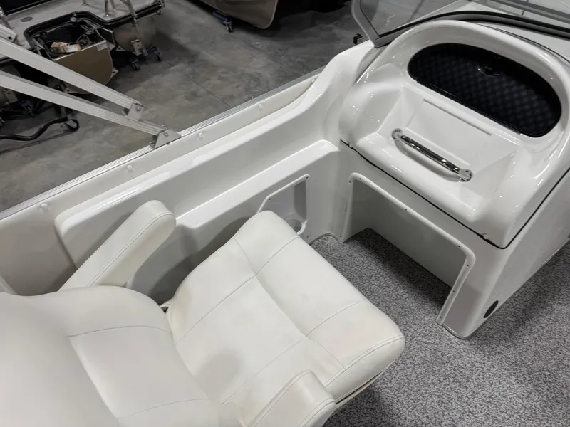 Slide: The Image of Interior of 2015 PlayCraft 2600 Sport Toon boat with white seating and dashboard. - 15