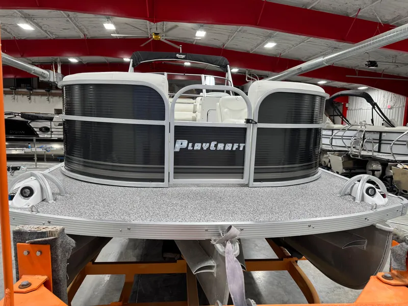 Slide: The Image of 2015 PlayCraft 2600 Sport Toon pontoon boat in indoor storage facility. - 5
