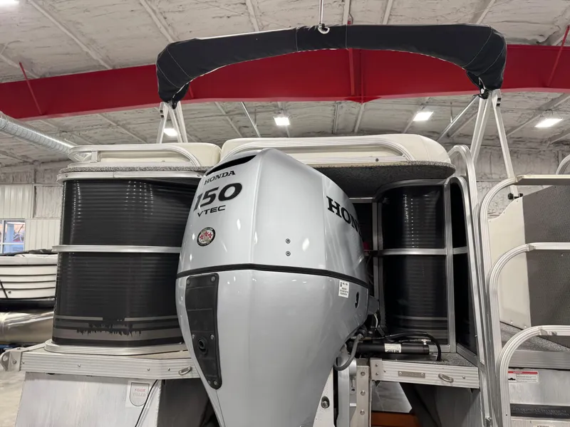 Slide: The Image of 2015 PlayCraft 2600 Sport Toon with Honda 150 VTEC engine in a warehouse. - 6