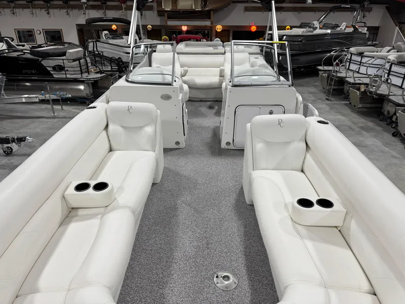 Slide: The Image of 2015 PlayCraft 2600 Sport Toon boat interior with white seating and cup holders. - 7