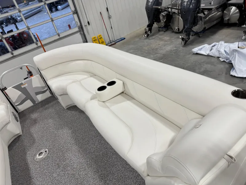 Slide: The Image of 2015 PlayCraft 2600 Sport Toon boat interior with white seating and cup holders. - 9