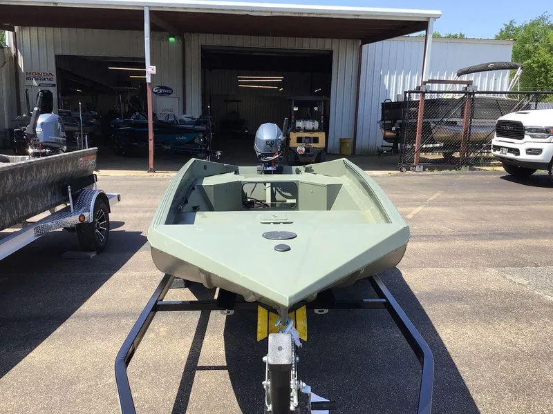 Slide: The Image of 2025 Edge Duck Boats 550-SP on trailer, parked outside a boat dealership. - 11