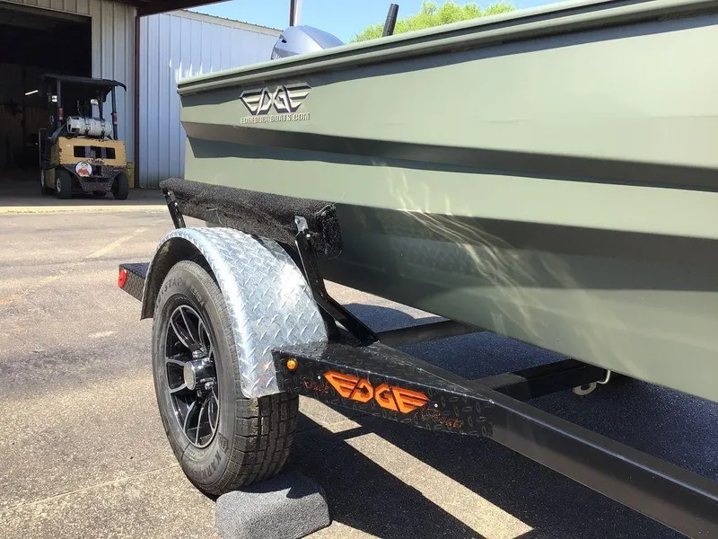 Slide: The Image of 2025 Edge Duck Boats 550-SP on trailer, parked outside a warehouse. - 15