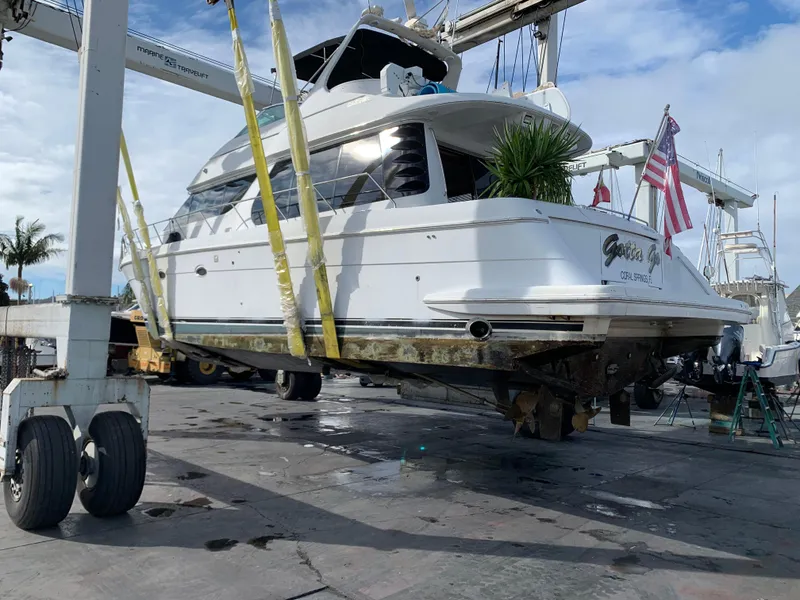 Slide: The Image of 2000 Carver 530 Voyager Pilothouse yacht on a lift, undergoing maintenance. - 10
